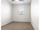 A carpeted bedroom features a ceiling fan and a window with blinds at 24134 N Cotton Cir, Florence, AZ 85132