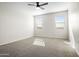 Bedroom featuring plush carpeting and natural light from two windows with a ceiling fan at 24134 N Cotton Cir, Florence, AZ 85132