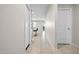 Bright hallway featuring tiled floors that leads to a kitchen with barstool seating at 24134 N Cotton Cir, Florence, AZ 85132