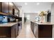 Stylish kitchen featuring dark cabinets, granite countertops and stainless steel appliances at 24134 N Cotton Cir, Florence, AZ 85132