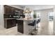 Modern kitchen featuring dark cabinetry, granite countertops and stainless steel appliances at 24134 N Cotton Cir, Florence, AZ 85132