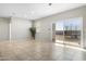 Neutral living room with tile flooring and sliding glass doors to the backyard at 24134 N Cotton Cir, Florence, AZ 85132