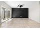 Living room with tile floors, sliding glass door and a decorative accent wall with a ceiling fan at 24134 N Cotton Cir, Florence, AZ 85132