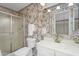 Bathroom with a shower, floral wallpaper, sink with vanity, and mirror at 2442 N 22Nd Ave, Phoenix, AZ 85009