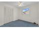 Cozy bedroom features a closet, ceiling fan, and window with neighborhood view at 2442 N 22Nd Ave, Phoenix, AZ 85009