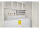 The laundry room has a side-by-side washer and dryer, with storage cabinets above at 2442 N 22Nd Ave, Phoenix, AZ 85009