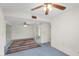 Open living space with carpet flooring, ceiling fan and access to a sliding glass door to an outdoor patio at 2442 N 22Nd Ave, Phoenix, AZ 85009