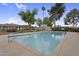 Community pool with clear blue water, surrounded by lush trees and well-maintained landscaping at 2442 N 22Nd Ave, Phoenix, AZ 85009