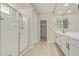 This bathroom features a tiled floor, glass shower, and dual sink vanity at 25948 W Sands Dr, Buckeye, AZ 85396