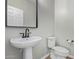 Stylish powder room featuring pedestal sink, and modern fixtures at 25948 W Sands Dr, Buckeye, AZ 85396