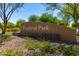 Festival Park community sign surrounded by desert landscaping and lush green trees at 25948 W Sands Dr, Buckeye, AZ 85396