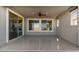 This covered patio features an exterior ceiling fan and sliding glass doors to the interior at 25948 W Sands Dr, Buckeye, AZ 85396