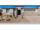 This home boasts desert landscaping and a two-car garage at 25948 W Sands Dr, Buckeye, AZ 85396