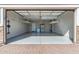 Spacious garage with epoxy floors, shelving and storage, and garage door opener at 25948 W Sands Dr, Buckeye, AZ 85396