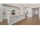 Well-equipped eat-in kitchen featuring stainless steel appliances, an island bar, and white cabinetry at 25948 W Sands Dr, Buckeye, AZ 85396