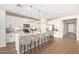 Well-equipped eat-in kitchen featuring stainless steel appliances, an island bar, and pendant lighting at 25948 W Sands Dr, Buckeye, AZ 85396