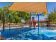 Community splash pad with shade canopy, water features, and palm tree accents at 25948 W Sands Dr, Buckeye, AZ 85396