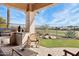 Outdoor kitchen and patio with golf course views at 27379 N Makena Pl, Peoria, AZ 85383