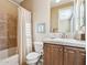 Traditional bathroom with a bathtub with tile surround and wooden vanity at 27379 N Makena Pl, Peoria, AZ 85383