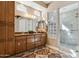 Elegant bathroom with double vanity, large walk-in shower, and glass block window at 27379 N Makena Pl, Peoria, AZ 85383