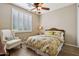 Charming bedroom with wood flooring, ceiling fan, and window shutters at 27379 N Makena Pl, Peoria, AZ 85383