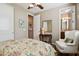 Comfortable bedroom with floral bedding, an armchair, and ensuite access at 27379 N Makena Pl, Peoria, AZ 85383