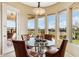 Breakfast nook with glass table and four chairs, overlooking the golf course at 27379 N Makena Pl, Peoria, AZ 85383