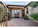 Front courtyard entry with wrought iron gate and brick pavers at 27379 N Makena Pl, Peoria, AZ 85383