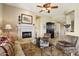 Living room with fireplace, seating area, and large windows at 27379 N Makena Pl, Peoria, AZ 85383