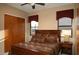 Large bedroom with a wooden bed frame and large windows at 28492 N 95Th Pl, Scottsdale, AZ 85262