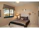 Guest bedroom with a rustic-style bed and window views at 28492 N 95Th Pl, Scottsdale, AZ 85262