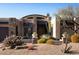 Stunning desert home exterior with stone accents and landscaping at 28492 N 95Th Pl, Scottsdale, AZ 85262