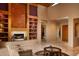 Elegant living room featuring a large fireplace and built-in shelving at 28492 N 95Th Pl, Scottsdale, AZ 85262