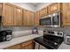 Stainless steel appliances and wood cabinets in kitchen at 2929 W Yorkshire Dr # 1118, Phoenix, AZ 85027