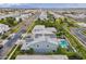 Aerial view of a home equipped with solar panels, lush backyard, pool, landscaping, and neighborhood at 2967 E Boot Track Trl, Gilbert, AZ 85296