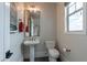 Charming bathroom with pedestal sink, toilet, and a window allowing natural light at 2967 E Boot Track Trl, Gilbert, AZ 85296