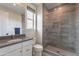 Modern bathroom featuring a tiled shower, vanity with sink, toilet and a window at 2967 E Boot Track Trl, Gilbert, AZ 85296