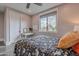 Bedroom featuring a large window with views and white decorative trim at 2967 E Boot Track Trl, Gilbert, AZ 85296