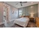 Cozy bedroom featuring a bed, a ceiling fan, and natural light from a window at 2967 E Boot Track Trl, Gilbert, AZ 85296