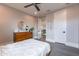 Cozy bedroom featuring a bed, dresser, and a ceiling fan at 2967 E Boot Track Trl, Gilbert, AZ 85296