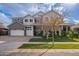 Beautiful two-story home with well-manicured lawn, three-car garage, and charming gray and white exterior at 2967 E Boot Track Trl, Gilbert, AZ 85296