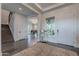 Bright foyer showcasing hardwood floors, staircase, and elegant decor leading to the main living areas at 2967 E Boot Track Trl, Gilbert, AZ 85296