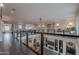 This lofted hallway includes glass railings, a chandelier and overlooks a fireplace at 2967 E Boot Track Trl, Gilbert, AZ 85296