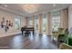 Elegant living room featuring a grand piano, recessed lighting, and large windows at 2967 E Boot Track Trl, Gilbert, AZ 85296