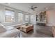 Bright living room featuring a cozy white couch, hardwood floors, and natural light from large windows at 2967 E Boot Track Trl, Gilbert, AZ 85296