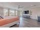 Well-lit main bedroom with hardwood floors, media center, and large windows at 2967 E Boot Track Trl, Gilbert, AZ 85296