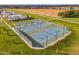 A distant aerial view of neighborhood tennis courts on a clear and sunny day at 2967 E Boot Track Trl, Gilbert, AZ 85296