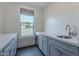 Wet bar with gray cabinetry, white countertops, stainless steel sink and faucet with view outside at 2967 E Boot Track Trl, Gilbert, AZ 85296