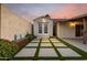 Backyard oasis featuring a storage shed, pavers with turf accents, and bench with accent pillows at 302 E Coral Gables Dr, Phoenix, AZ 85022