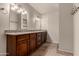 Bathroom features double vanity with granite countertops, cabinets, and neutral colored walls at 302 E Coral Gables Dr, Phoenix, AZ 85022